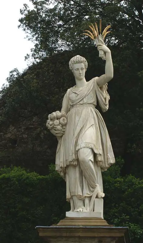 A depiction of the Greek Goddess of Demeter holding grain