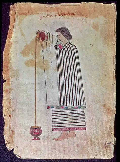 A woman pouring chocolate from one vessel to another. 