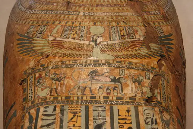 A portrait of Egyptian Goddess with her wings spread around the coffin