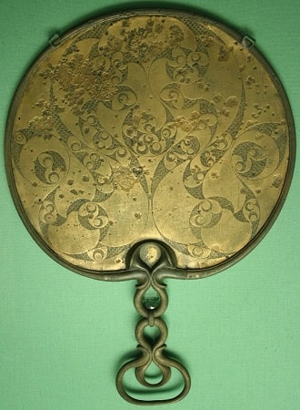 The reverse side of a bronze mirror, shows the spiral decorative theme