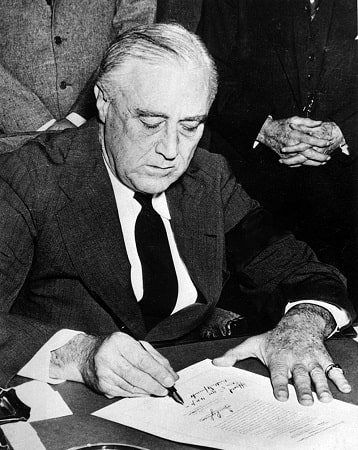 President Roosevelt signs the Declaration of War on Japan on December 8 1941