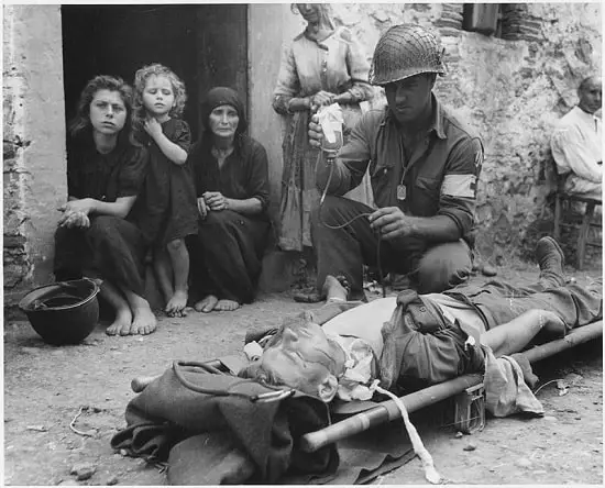Private Roy W. Humphrey getting blood plasma in Sicily, August 1943