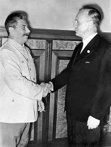 Stalin and Ribbentrop shaking hands after the signing of the pact