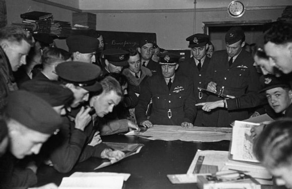 Wellington crews studying maps at a briefing with the station commander, September 1940